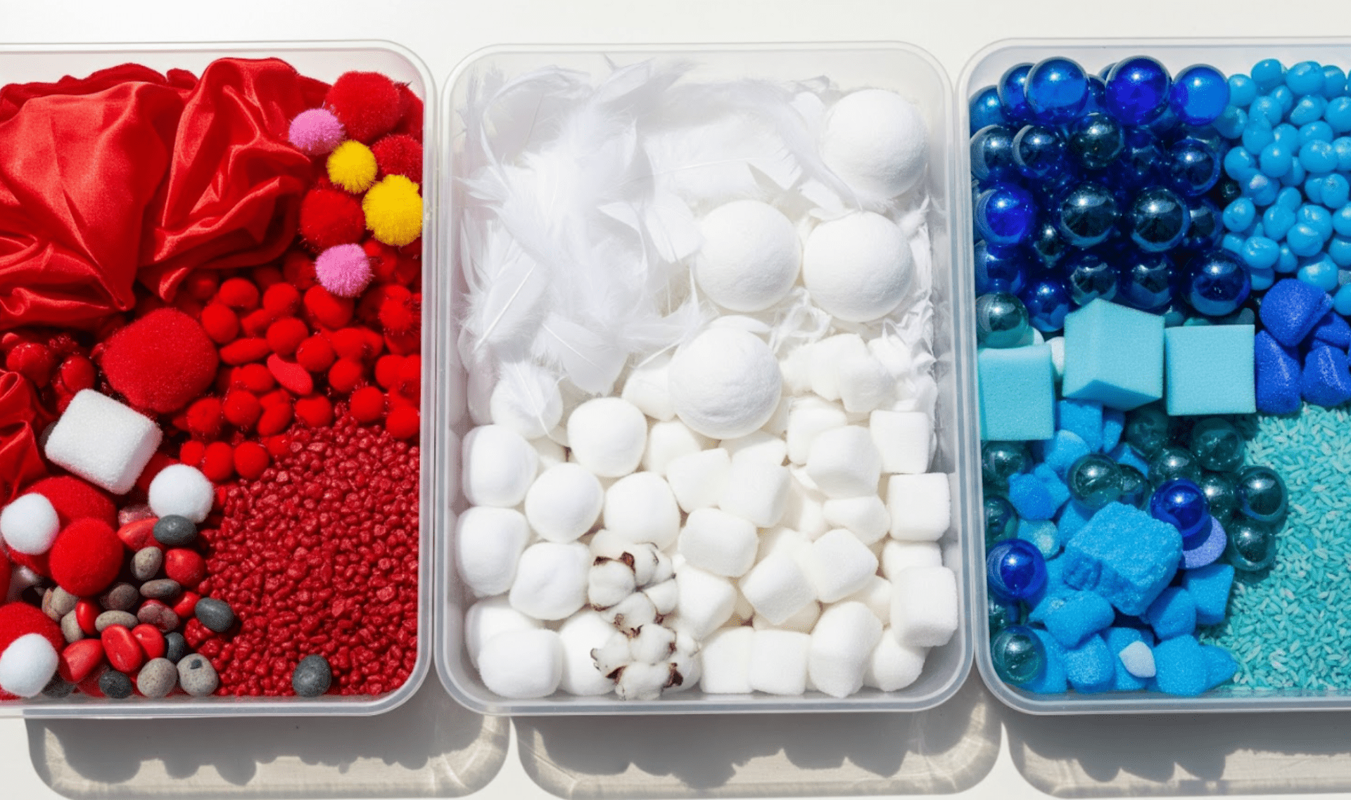 Child enjoying patriotic sensory activity with red, white, and blue materials